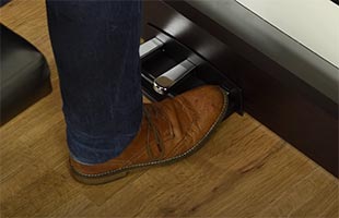 close-up image of musician's foot pressing sustain pedal on Korg C1 Air