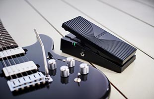 side view of Boss EV-1-WL sitting on floor alongside Boss Eurus GS-1 Electronic Guitar (sold separately)