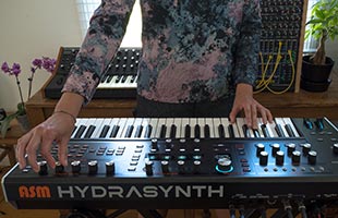 close-up front view of musician playing ASM Hydrasynth Keyboard in home studio