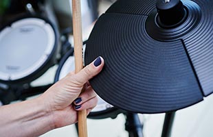 close-up image of drummer's hand choking CY-5 crash cymbal pad included in Roland TD-07DMK