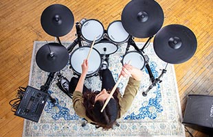 overhead view of drummer playing Roland TD-50K2 in practice space