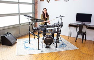 front view of drummer playing Roland TD-50K2 in practice space